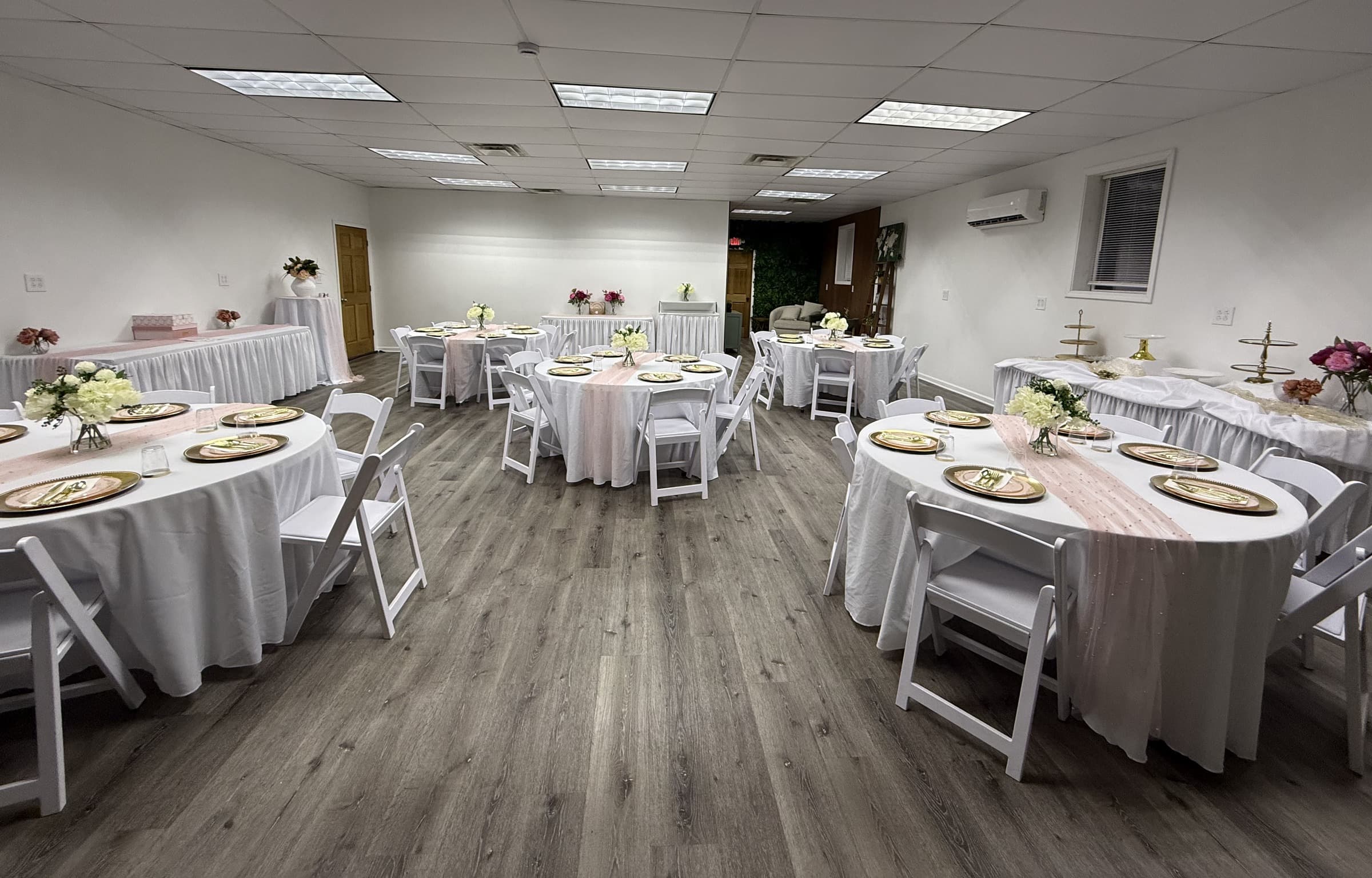 The Ehnita Studio dressed in blush and gold for a shower, with the plant wall behind